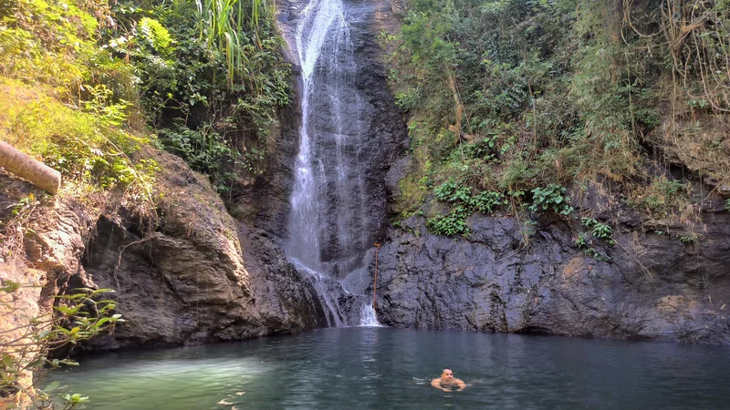 Guest swimming in the natural pool below Kuyawyaw Falls near Taytay, Palawan