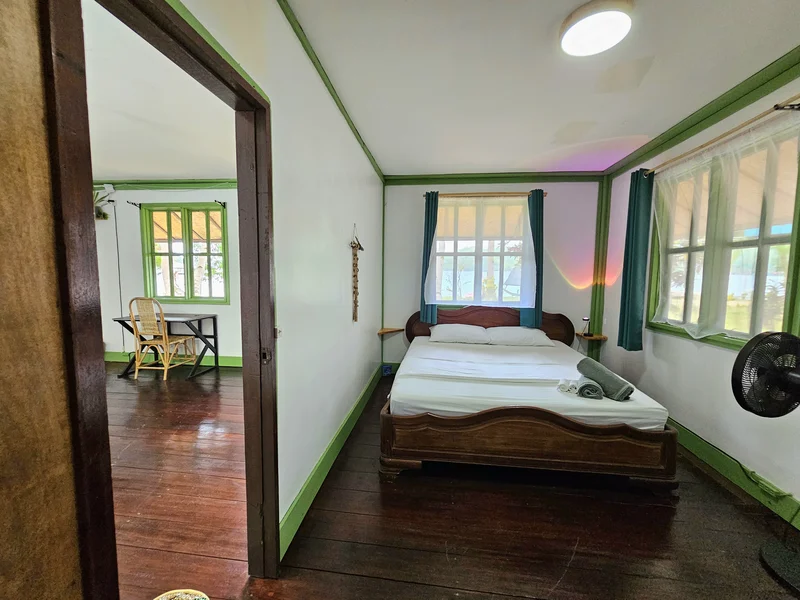 Double-bed room with green window trim and natural light at DK2 Resort, Palawan